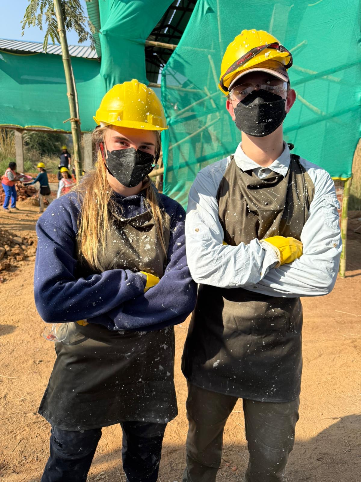 Two participants in masks read for lime plastering